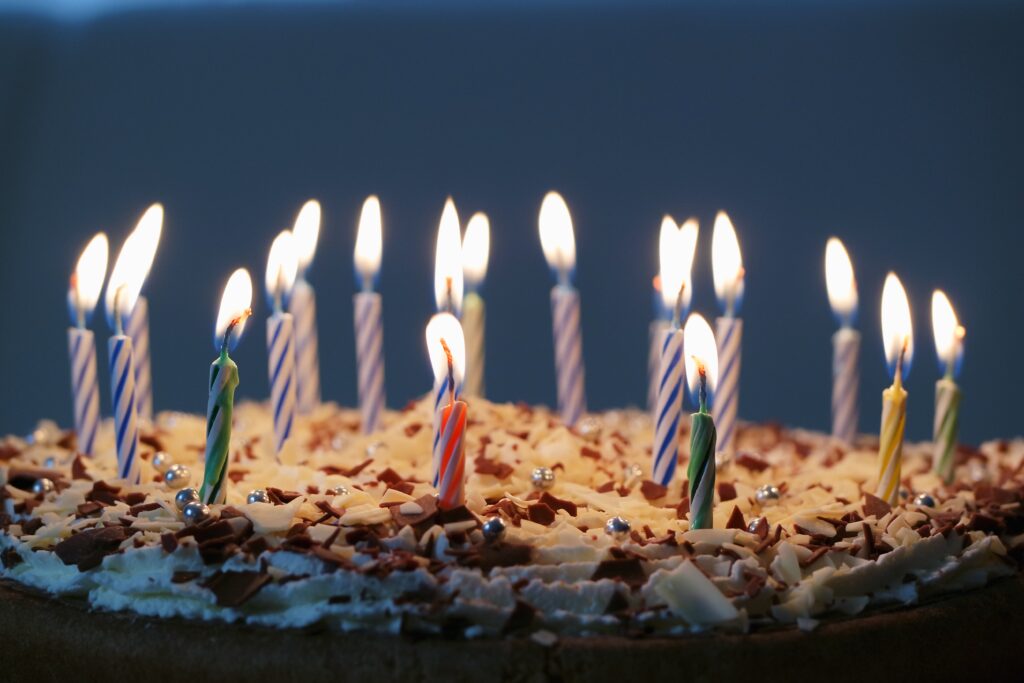 Colorful candles lit on a birthday cake