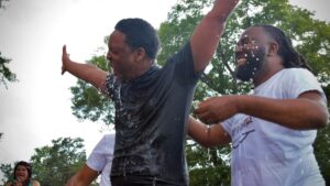 Man rejoices after being baptized outside at church plant