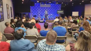 Juan Aristizabal preaches in front of a congregation at Westwood en Español.