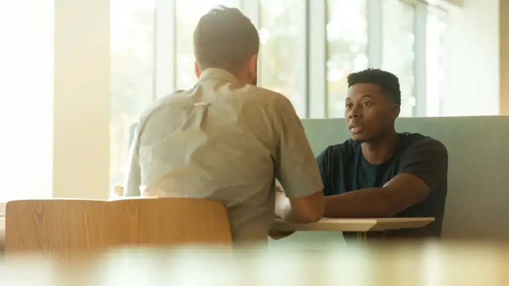 Men having a discussion seated at a table