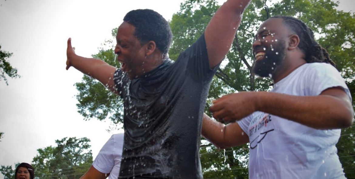 Man rejoices after being baptized outside at church plant