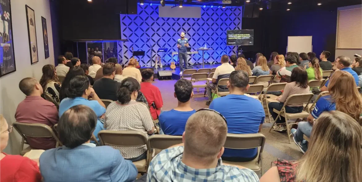 Juan Aristizabal preaches in front of a congregation at Westwood en Español.